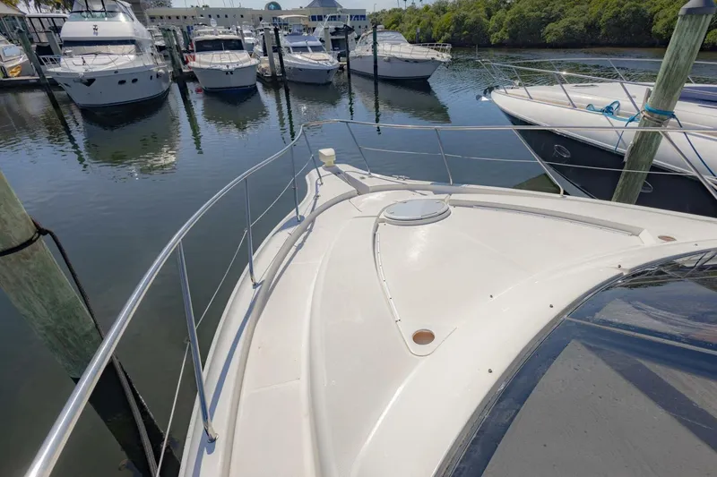 Slide: The Image of 2001 Silverton 410 Sport Bridge yacht docked at marina, surrounded by other boats. - 46
