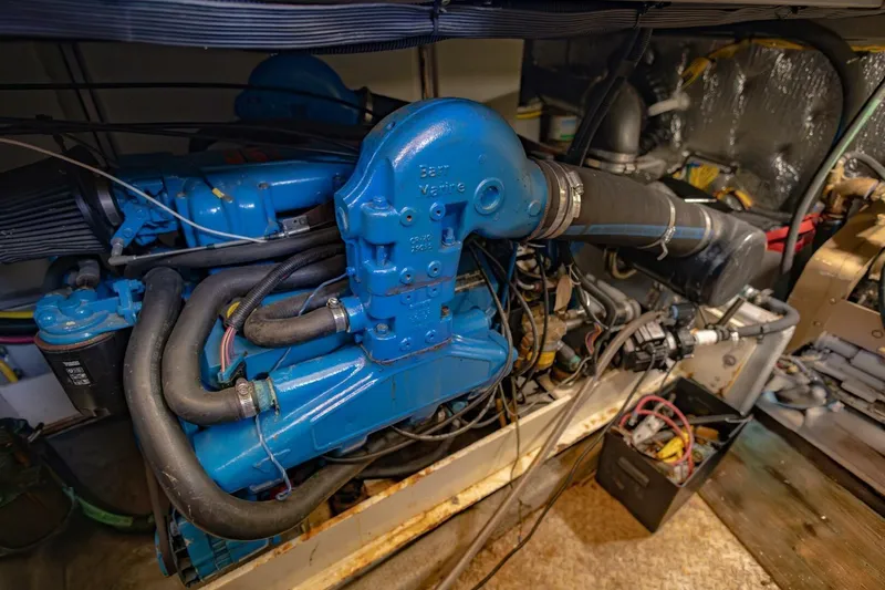 Slide: The Image of Engine room of a 2001 Silverton 410 Sport Bridge, showcasing blue marine engine components. - 56