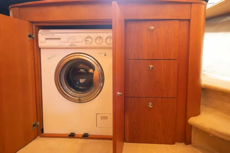 Slide: The Image of 2001 Silverton 410 Sport Bridge interior with built-in washer and wooden cabinetry. - 9