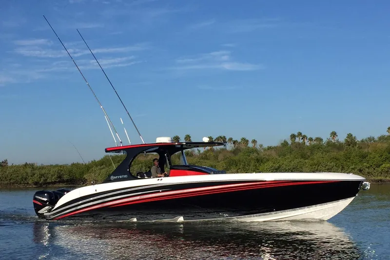 The Image of 2017 Mystic Powerboats M4200 cruising on a sunny day, featuring sleek design and vibrant colors. - 1