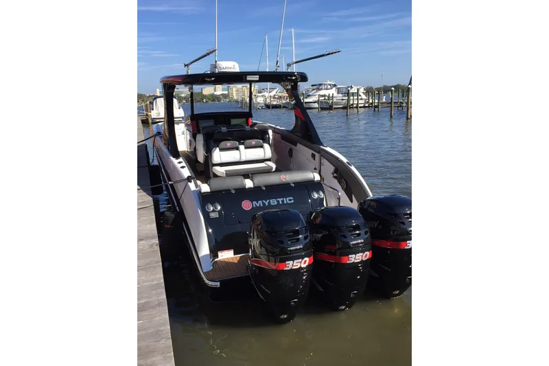 Slide: The Image of 2017 Mystic Powerboats M4200 with triple 350 Verado engines docked at marina. - 3
