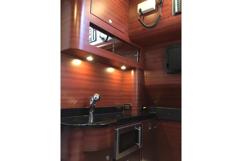 Slide: The Image of Luxurious 2017 Mystic Powerboats M4200 interior with sleek wood finish and modern amenities. - 8