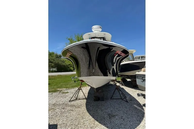 Slide: The Image of 2013 NauticStar 2500XS Offshore boat on stands, viewed from the front. - 4