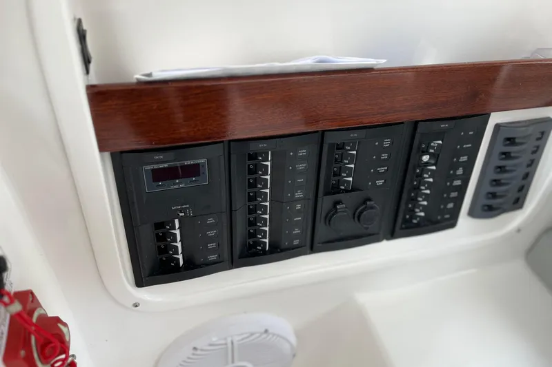 Slide: The Image of Control panel of 2025 NorthCoast 285 HT boat with switches and gauges. - 11