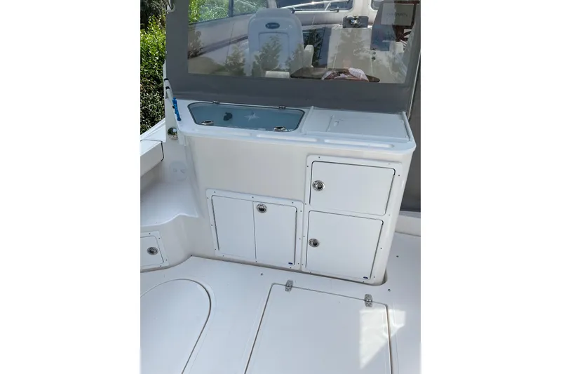 Slide: The Image of 2025 NorthCoast 285 HT boat interior with storage compartments and sink. - 12