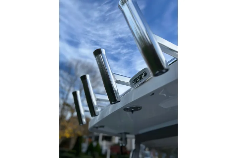 Slide: The Image of Stainless steel rod holders on 2025 NorthCoast 285 HT boat under blue sky. - 20