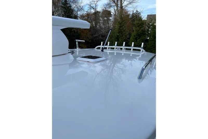 Slide: The Image of Rooftop view of 2025 NorthCoast 285 HT boat with rod holders and hatch. - 21