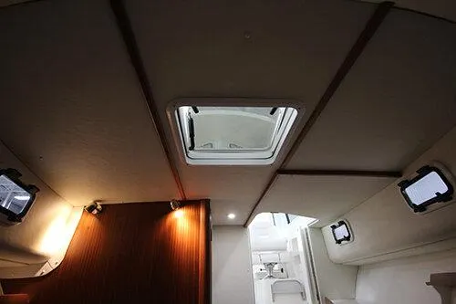 Slide: The Image of Manufacturer Provided Image: Interior view of 2025 NorthCoast 285 HT boat, featuring ceiling hatch and modern lighting. - 23