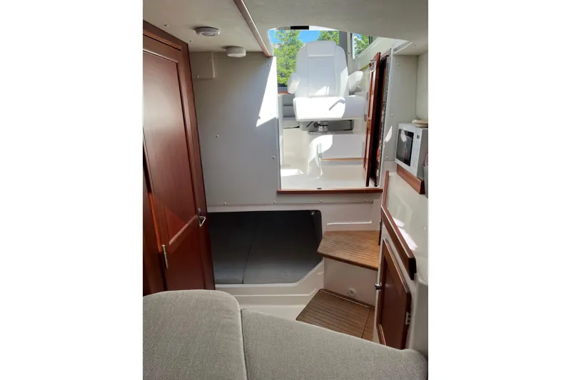 Slide: The Image of Interior of 2025 NorthCoast 285 HT boat with modern seating and wooden accents. - 25