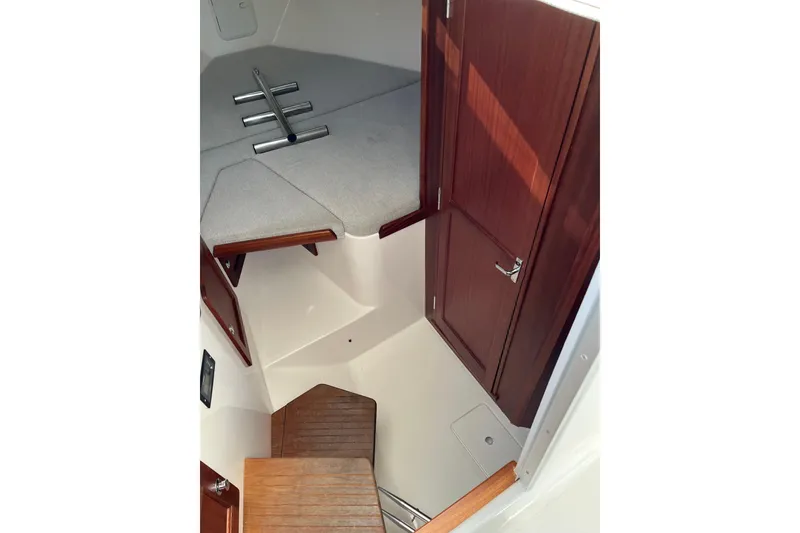 Slide: The Image of Interior of 2025 NorthCoast 285 HT boat with wooden accents and seating area. - 26