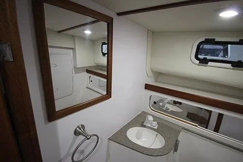 Slide: The Image of Manufacturer Provided Image: 2025 NorthCoast 285 HT boat interior bathroom with sink, mirror, and window. - 27