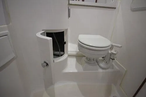 Slide: The Image of Manufacturer Provided Image: 2025 NorthCoast 285 HT boat bathroom with compact toilet and storage cabinet. - 29