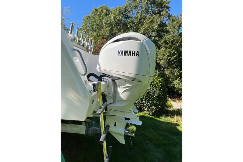 Slide: The Image of 2025 NorthCoast 285 HT boat with Yamaha outboard motor, set against a lush green backdrop. - 3