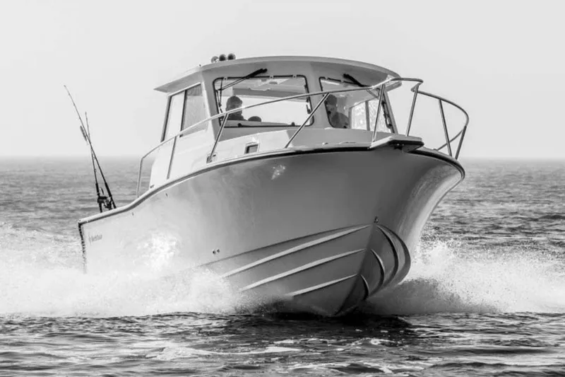 Slide: The Image of Manufacturer Provided Image: 2025 NorthCoast 285 HT boat cruising on open water, front view. - 33