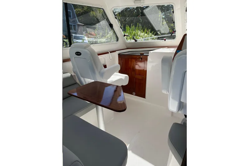 Slide: The Image of Interior of 2025 NorthCoast 285 HT boat with seating and wooden accents. - 8