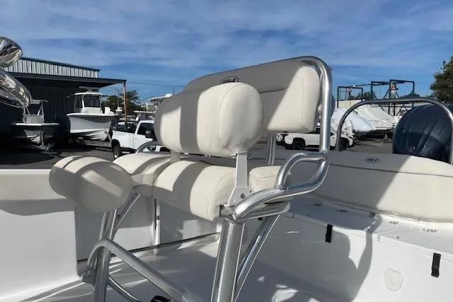 Slide: The Image of 2024 Sea Hunt Ultra 229 boat interior with cushioned seating and stainless steel frame. - 10