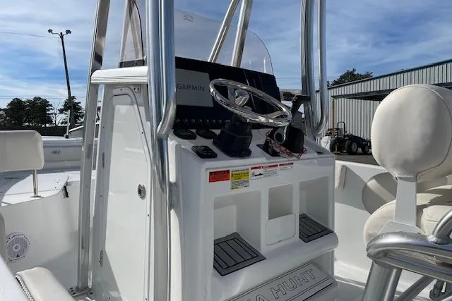 Slide: The Image of 2024 Sea Hunt Ultra 229 boat console with steering wheel and navigation equipment. - 9