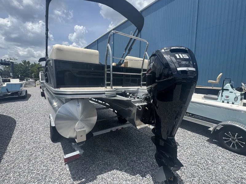 Slide: The Image of A 2026 Lowe LS Walk Thru 210 pontoon boat with a Mercury 115 HP outboard motor. - 4
