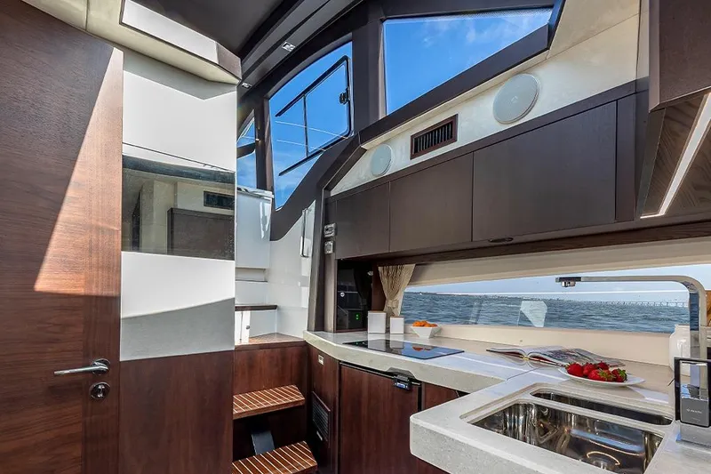 Slide: The Image of 2023 Galeon 425 HTS yacht interior with waterfront city view. - 12