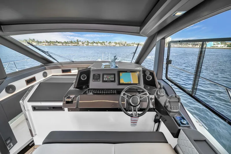 Slide: The Image of Interior view of 2023 Galeon 425 HTS yacht cockpit with navigation controls and sea view. - 22