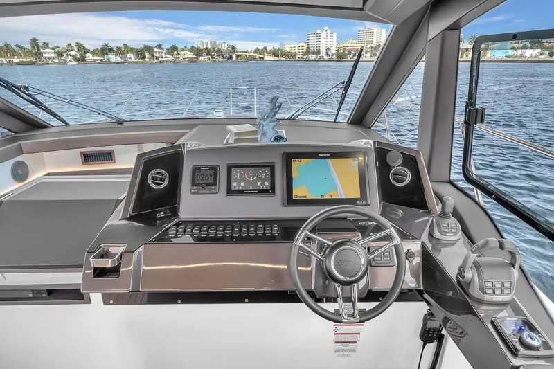 Slide: The Image of 2023 Galeon 425 HTS yacht helm with advanced navigation system and waterfront view. - 23