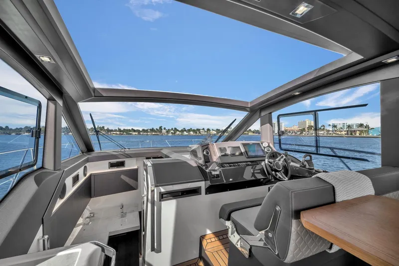 Slide: The Image of 2023 Galeon 425 HTS yacht interior with modern helm and panoramic windows. - 24