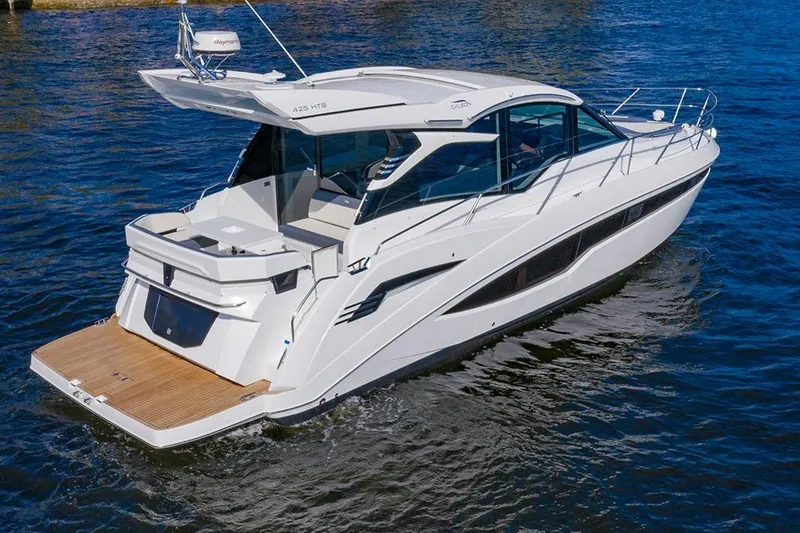 Slide: The Image of 2023 Galeon 425 HTS yacht on water with cityscape background. - 3