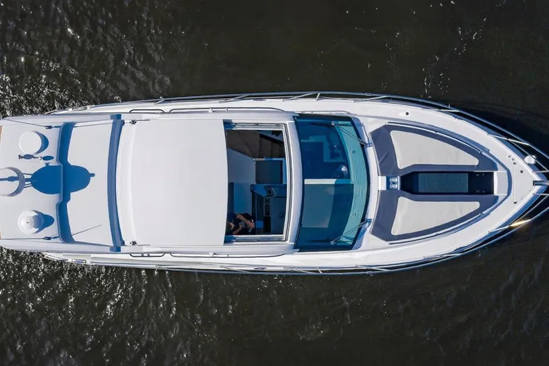 Slide: The Image of 2023 Galeon 425 HTS yacht cruising near coastal city skyline. - 4