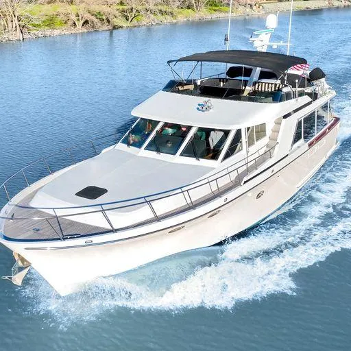 The Image of 1991 Vic Franck 65 Pilot House yacht cruising on a calm river. - 0