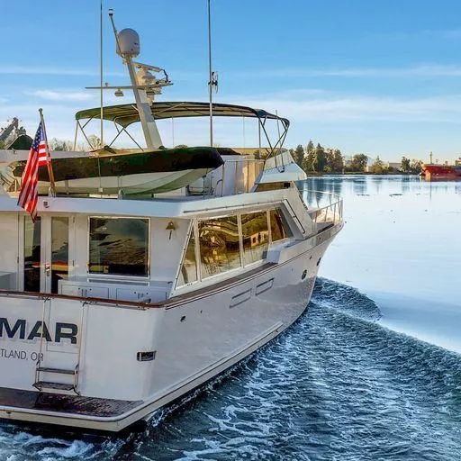 Slide: The Image of 1991 Vic Franck 65 Pilot House yacht cruising on a serene lake. - 10