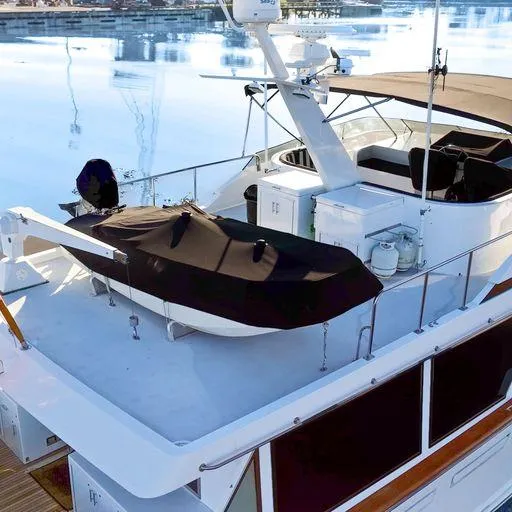 Slide: The Image of Vic Franck 65 Pilot House 1991 yacht with covered dinghy on deck. - 14