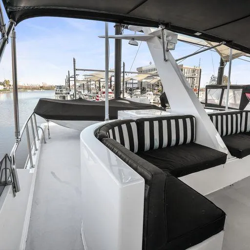 Slide: The Image of 1991 Vic Franck 65 Pilot House yacht with black and white seating on deck. - 25