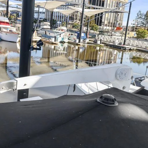 Slide: The Image of 1991 Vic Franck 65 Pilot House yacht docked at a marina with other boats. - 29