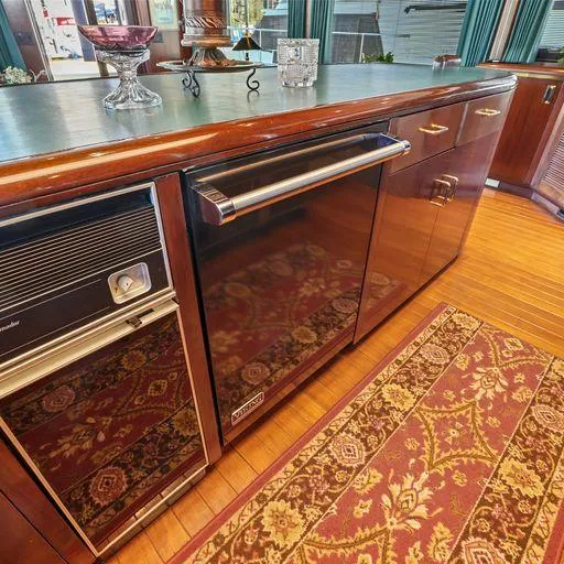 Slide: The Image of Vic Franck 65 Pilot House 1991 yacht interior with kitchen appliances and decorative rug. - 40
