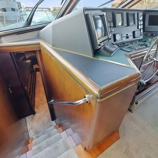 Slide: The Image of Pilot house interior of a 1991 Vic Franck 65 Pilot House yacht, featuring navigation equipment. - 49