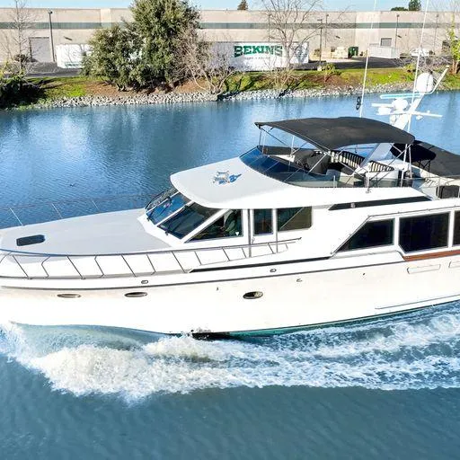 Slide: The Image of 1991 Vic Franck 65 Pilot House yacht cruising on a calm river. - 5