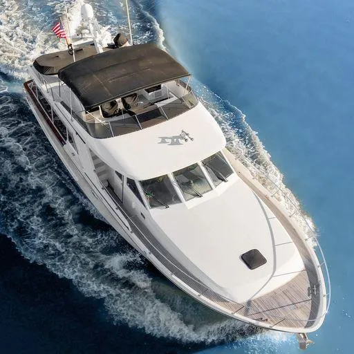 Slide: The Image of Aerial view of a 1991 Vic Franck 65 Pilot House yacht cruising on blue waters. - 8