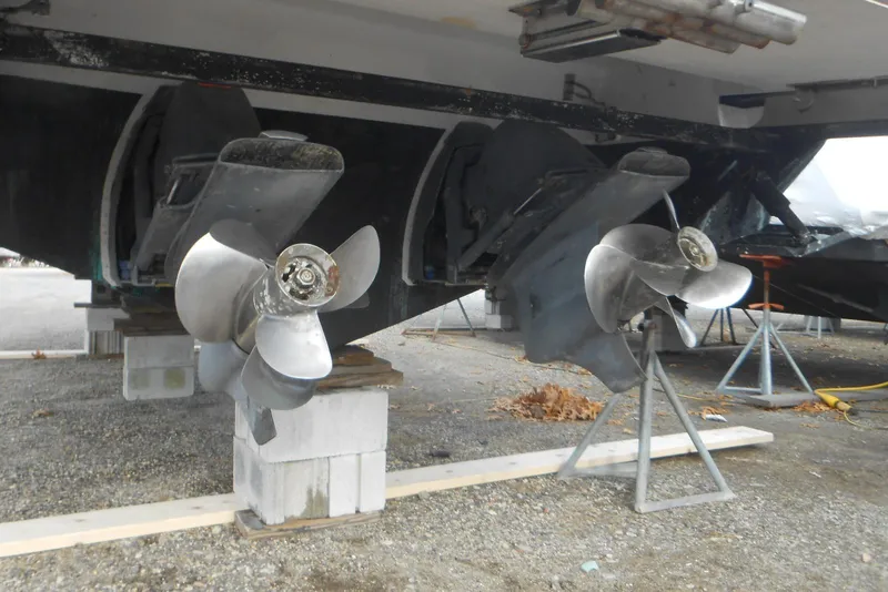 Slide: The Image of 2020 Cobalt A36BR boat propellers on stands, displayed outdoors. - 18