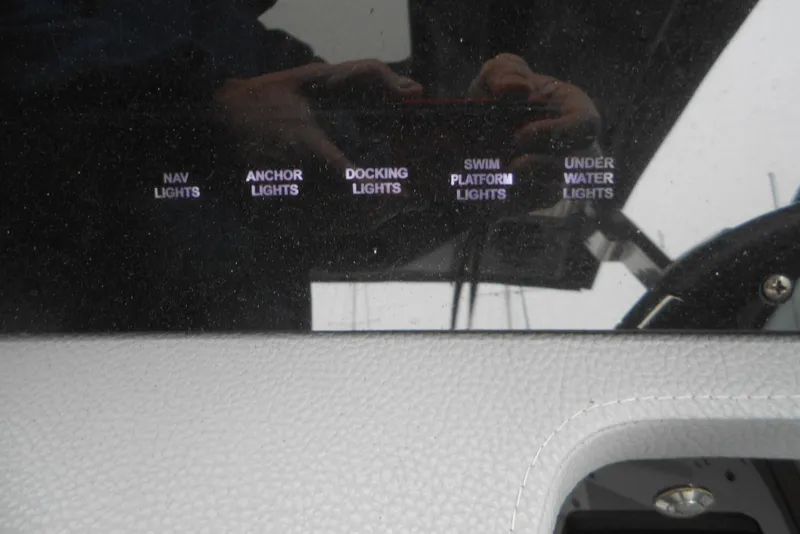 Slide: The Image of Control panel of 2020 Cobalt A36BR boat with various light switches. - 41