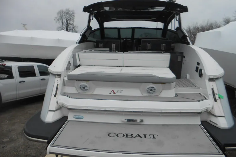 Slide: The Image of 2020 Cobalt A36BR boat with spacious seating and sleek design, parked outdoors. - 55