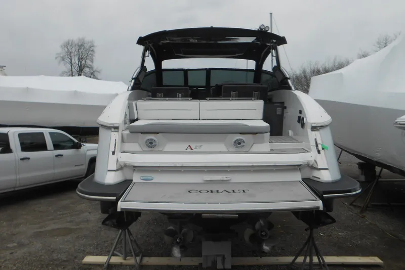 Slide: The Image of 2020 Cobalt A36BR boat, rear view, parked on a trailer in a storage area. - 56