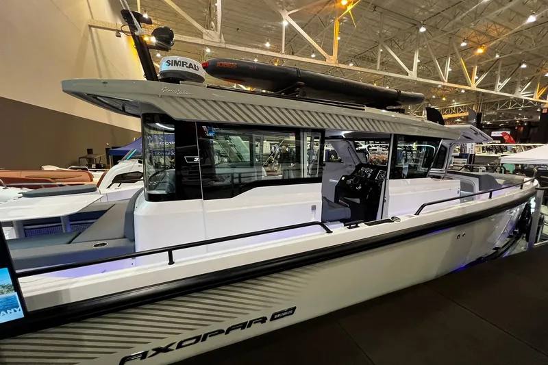 The Image of 2026 Axopar 37 XC Cross Cabin boat displayed indoors at a boat show. - 0