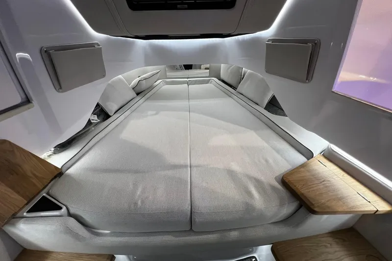Slide: The Image of 2026 Axopar 37 XC Cross Cabin interior with cozy sleeping area and wooden accents. - 15