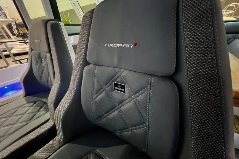 Slide: The Image of 2026 Axopar 37 XC Cross Cabin seats with premium stitching and branding. - 19