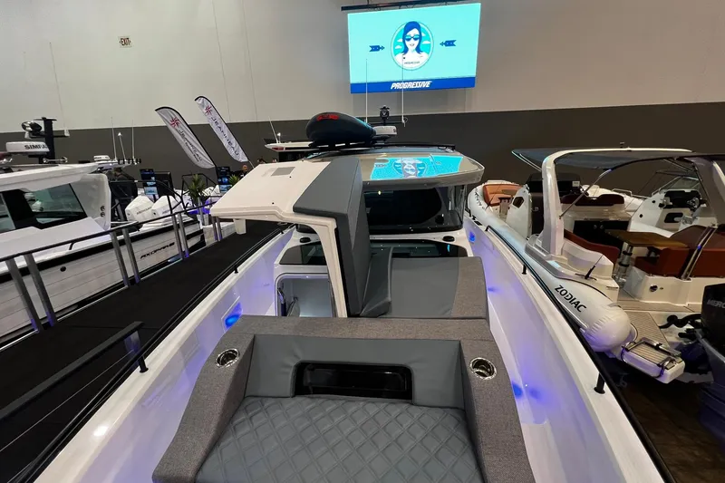 Slide: The Image of 2026 Axopar 37 XC Cross Cabin boat displayed at an indoor boat show. - 21