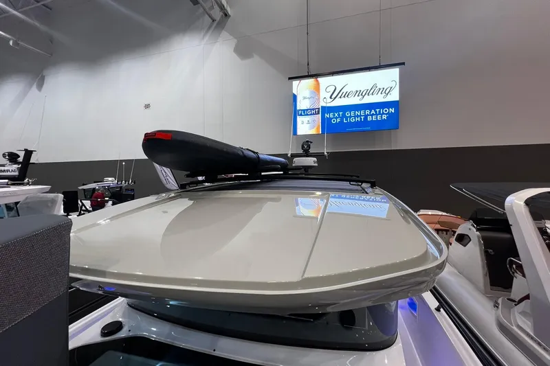 Slide: The Image of 2026 Axopar 37 XC Cross Cabin boat roof with mounted equipment at indoor exhibition. - 22