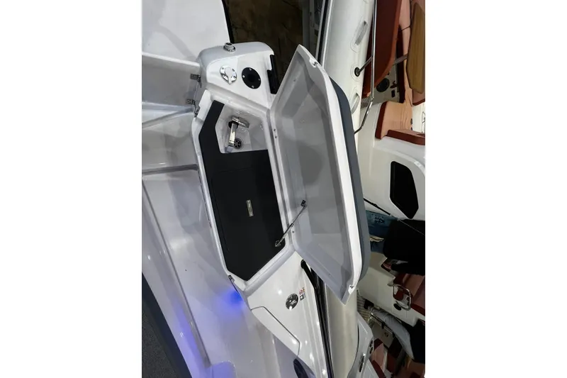 Slide: The Image of Open storage compartment on 2026 Axopar 37 XC Cross Cabin boat. - 25