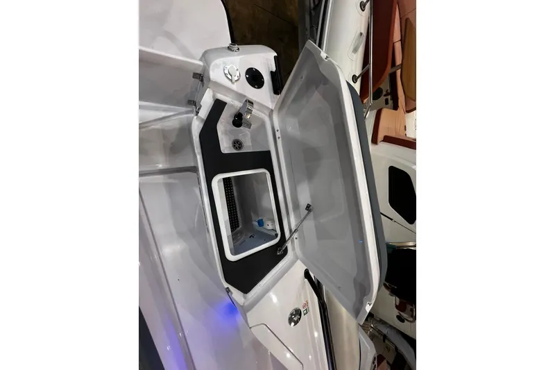 Slide: The Image of Open storage compartment on 2026 Axopar 37 XC Cross Cabin boat. - 26