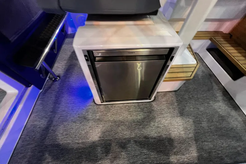 Slide: The Image of Compact refrigerator inside 2026 Axopar 37 XC Cross Cabin boat interior. - 30