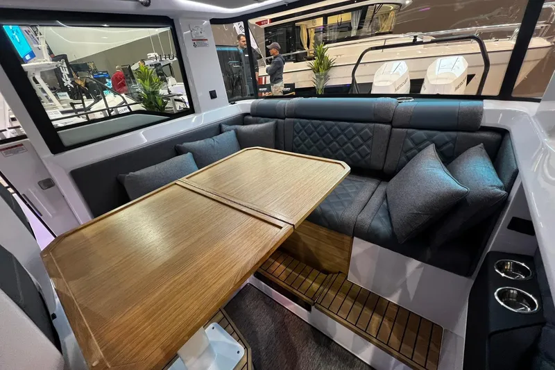 Slide: The Image of Luxurious interior of 2026 Axopar 37 XC Cross Cabin with elegant seating and wooden table. - 32